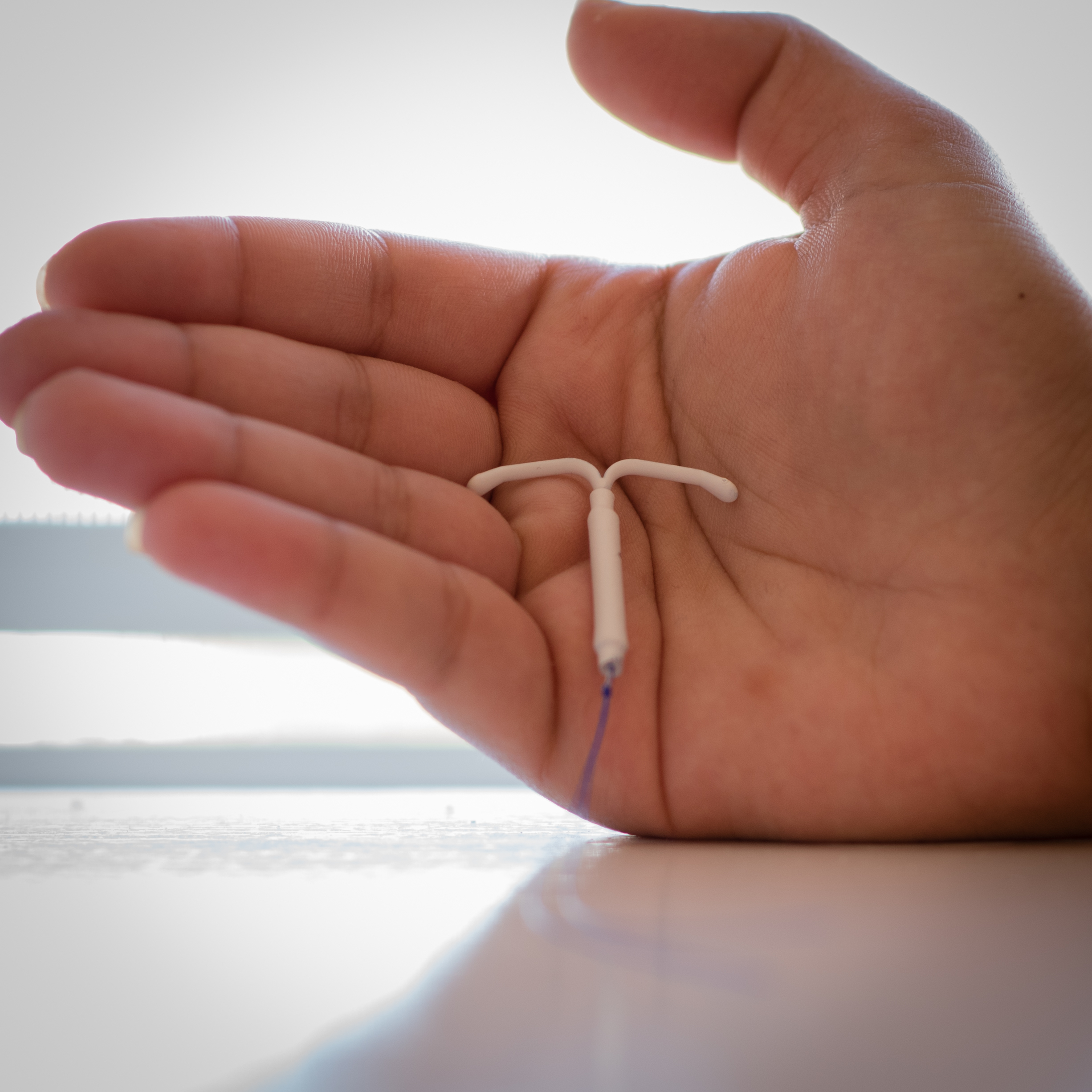 an IUD in the open palm of a person's hand