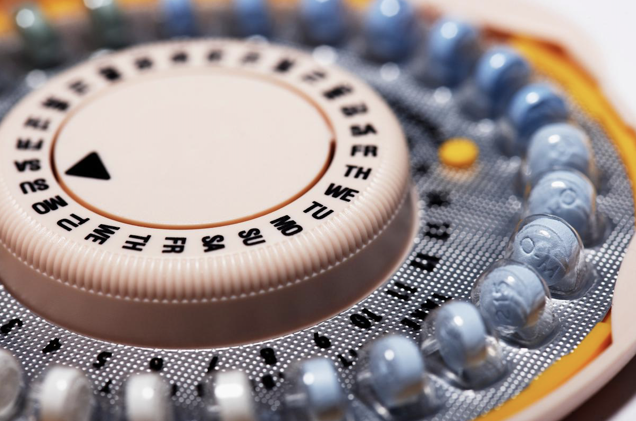 closeup of a pack of oral contraceptives with abbreviations for the days of the week 