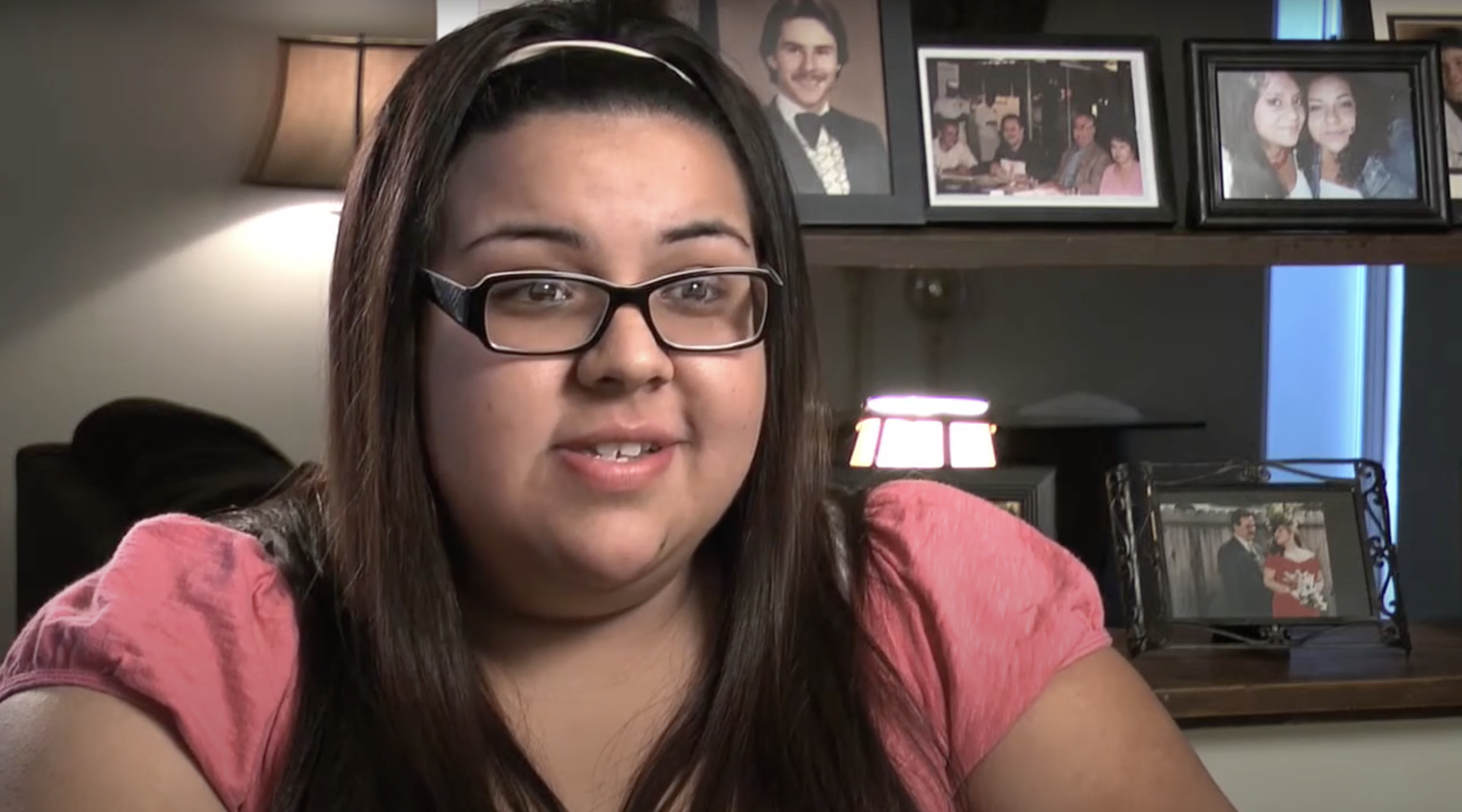 BIPOC woman with dark hair, glasses and a pink shirt talking about her birth control