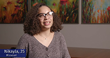 BIPOC woman in glasses and a brown sweater talking about her experience with birth control