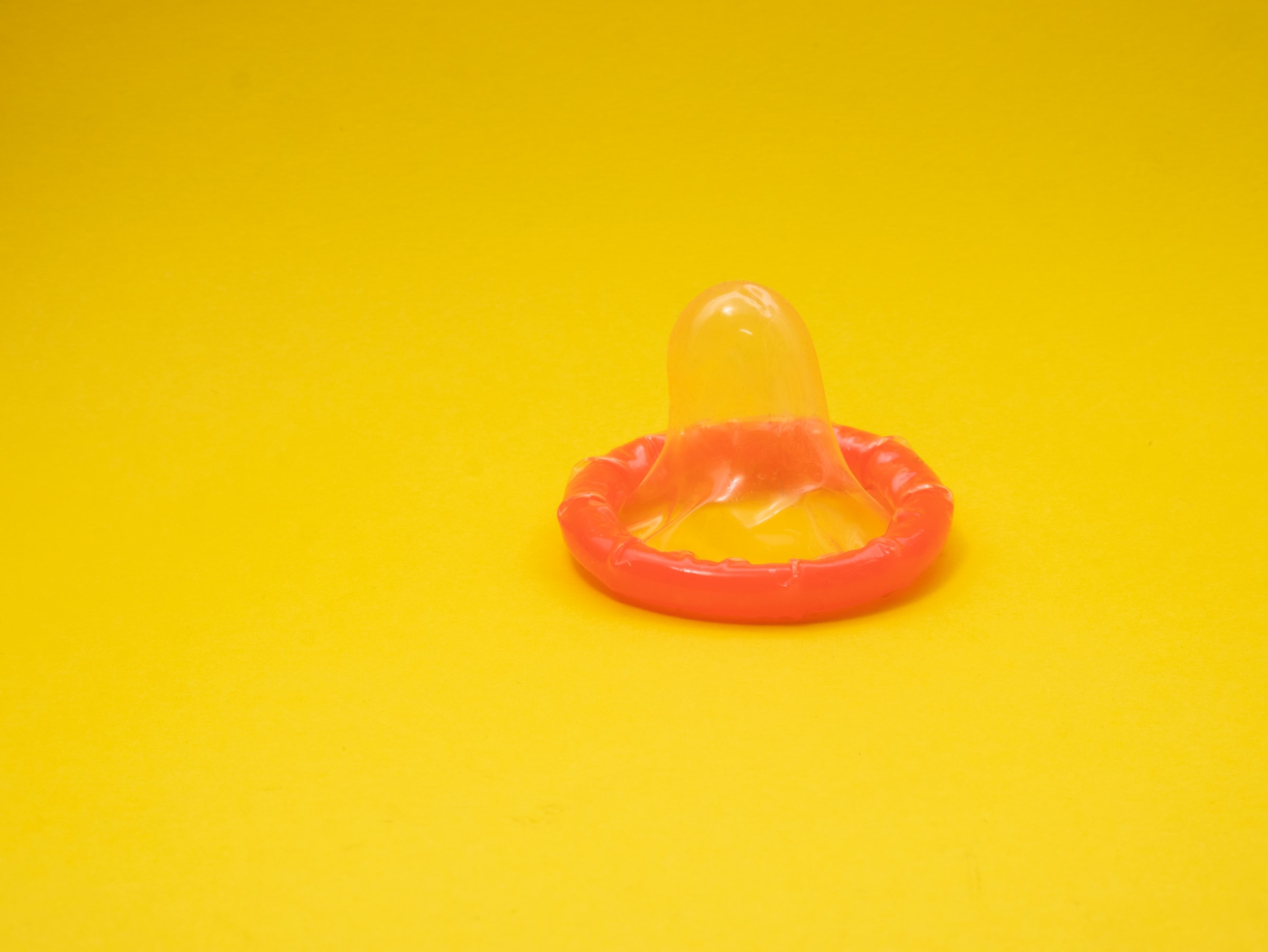 orange condom on a yellow background