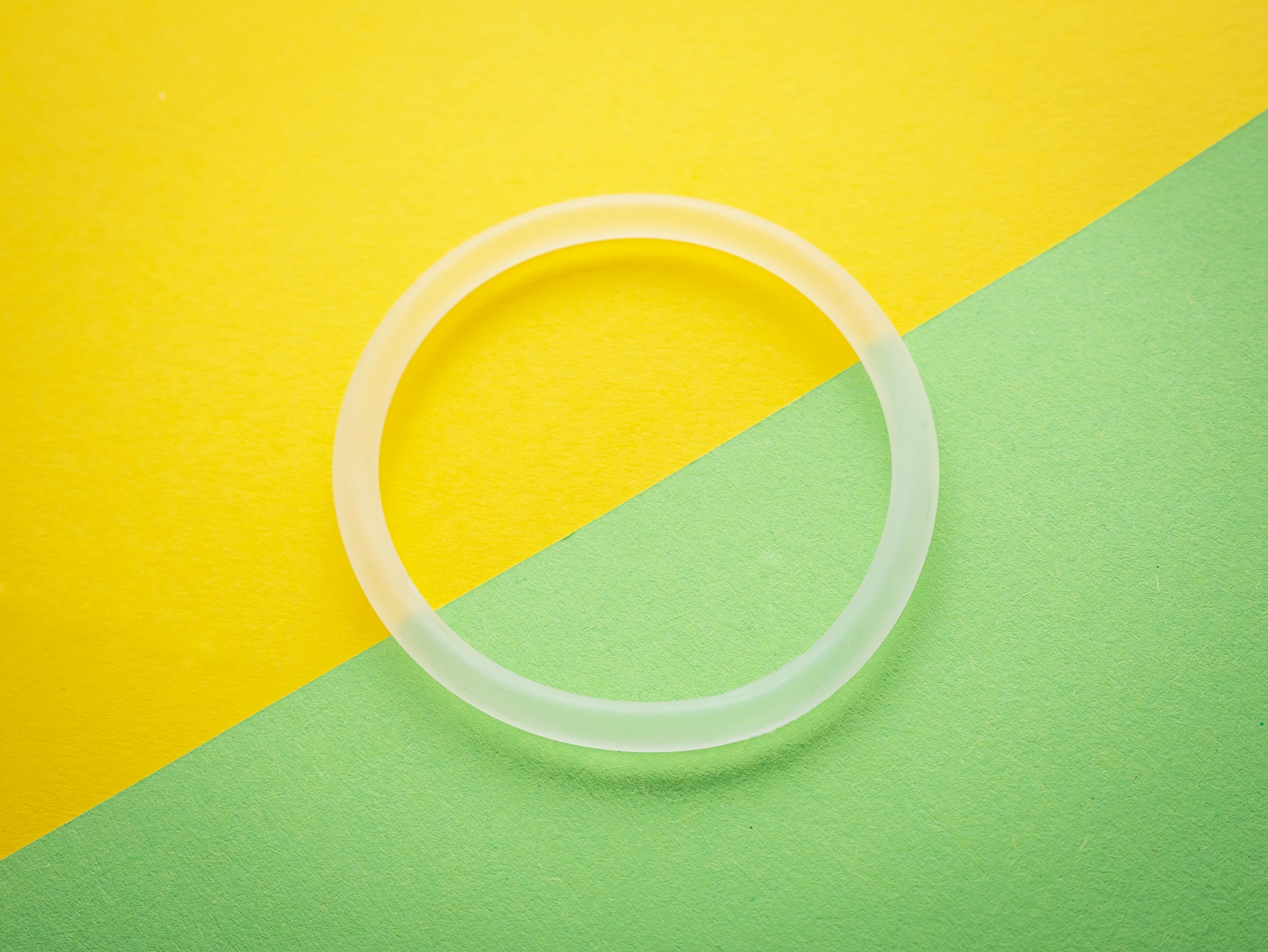 the ring birth control on a yellow and green background