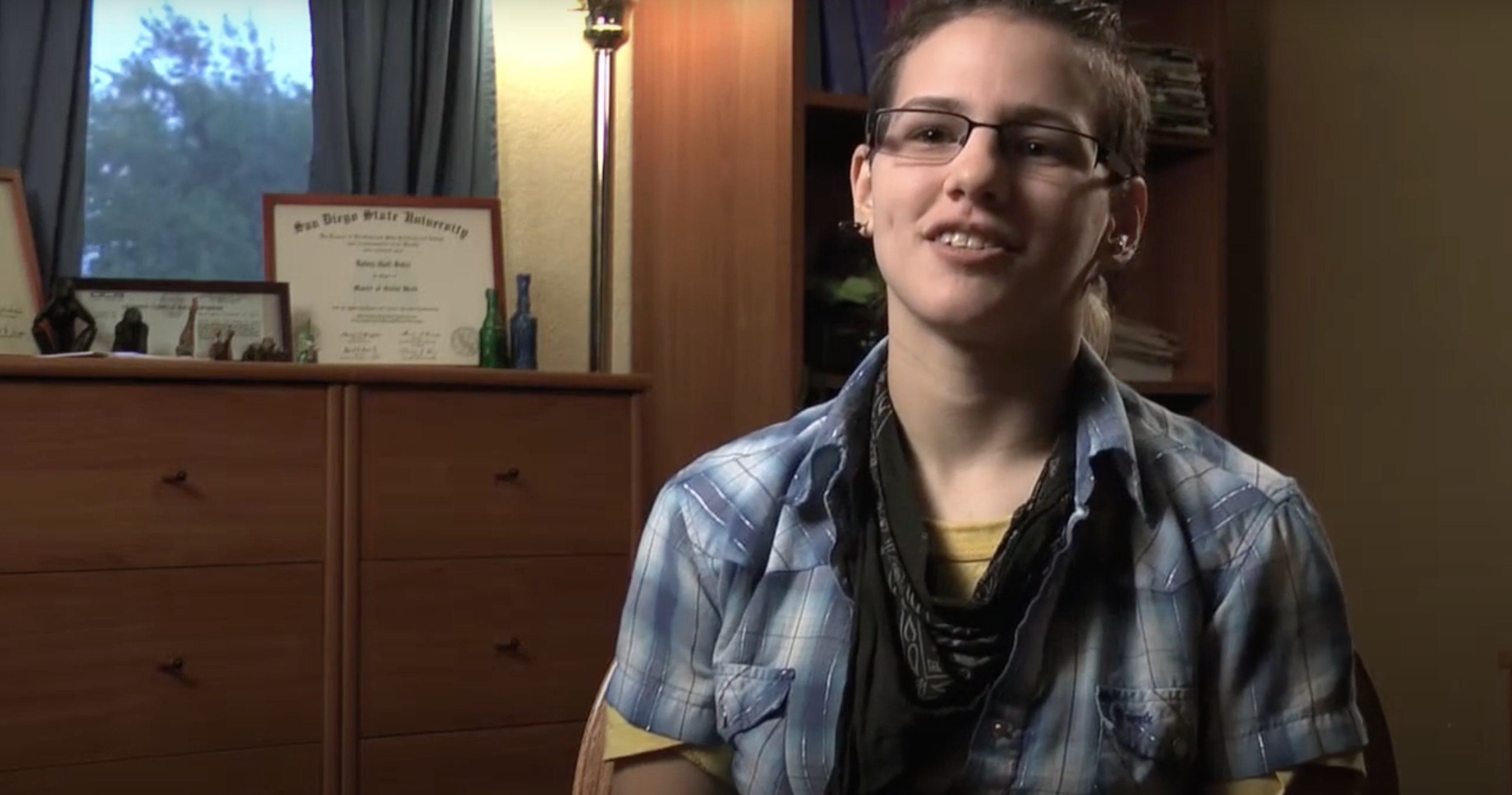 person in blue plaid shirt and glasses talking about their birth control method