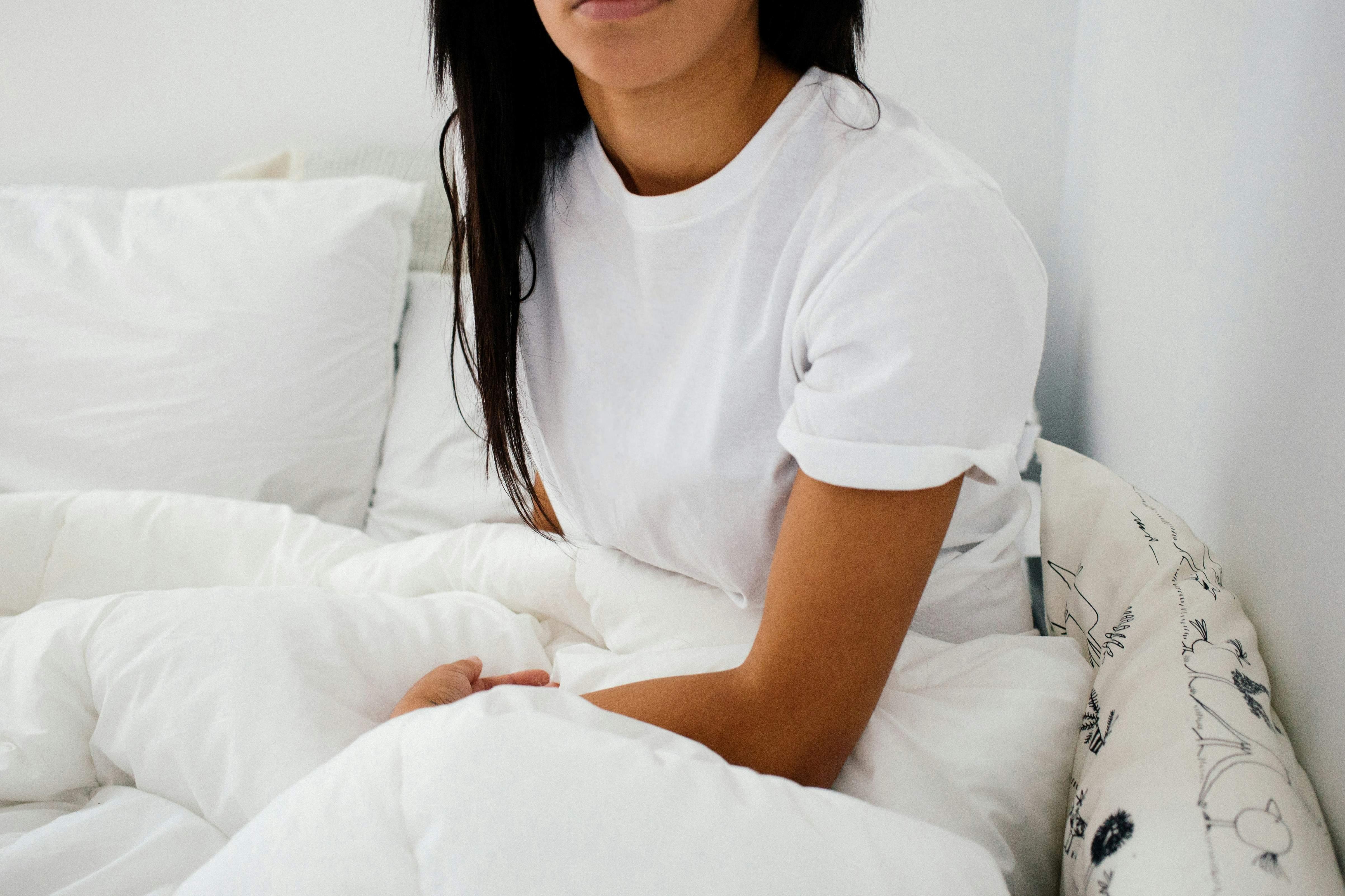 woman sitting on her bed