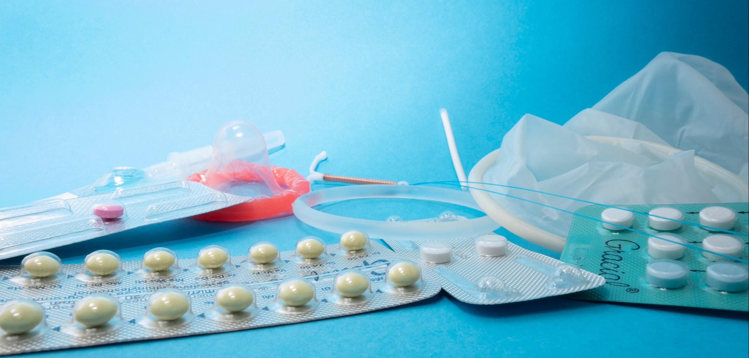 several birth control methods laid out on a blue background