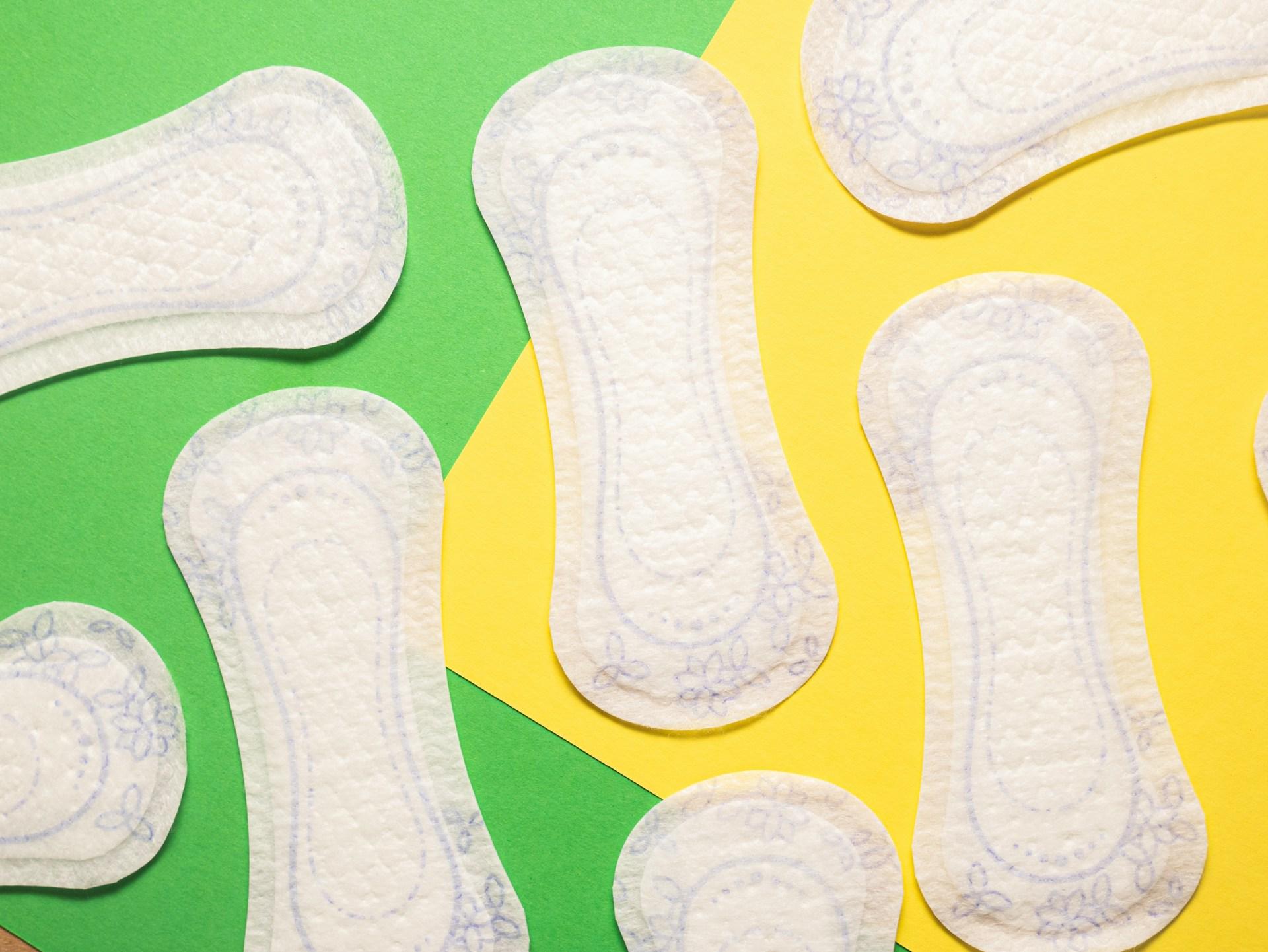 sanitary pads on a green and yellow background