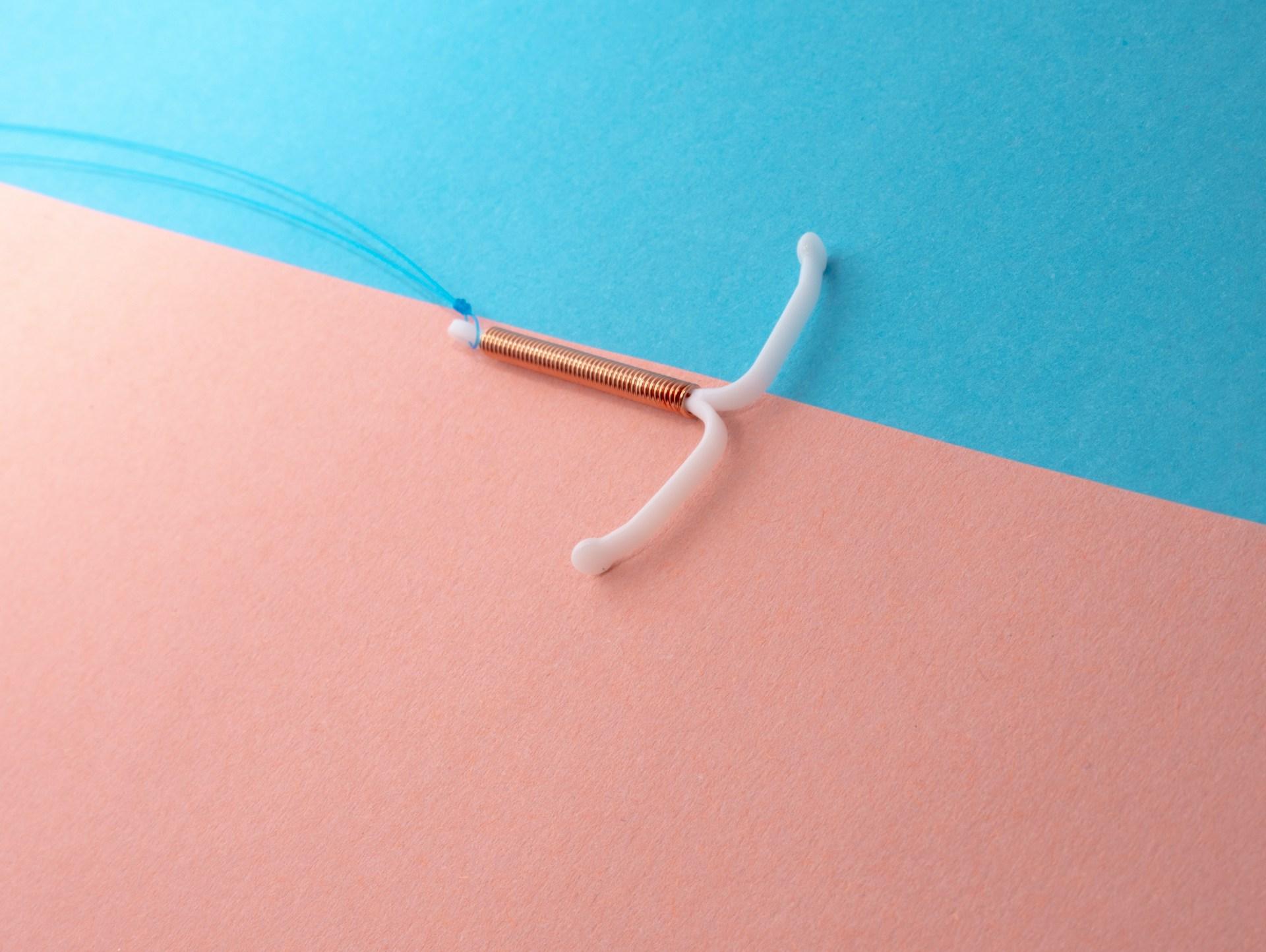 IUD on a pink and blue background