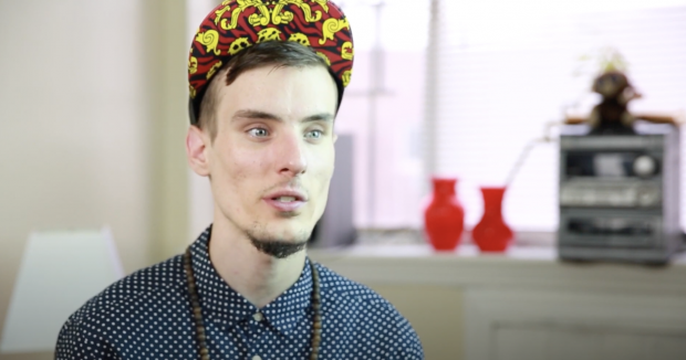 person in hat and blue shirt talking to camera