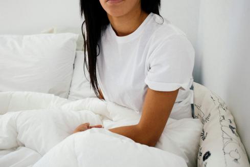 woman sitting on her bed