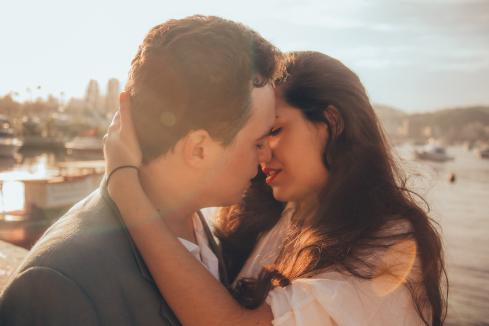 male and female couple embracing, about to kiss