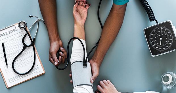 bird's eye view of a provider taking a patient's blood pressure