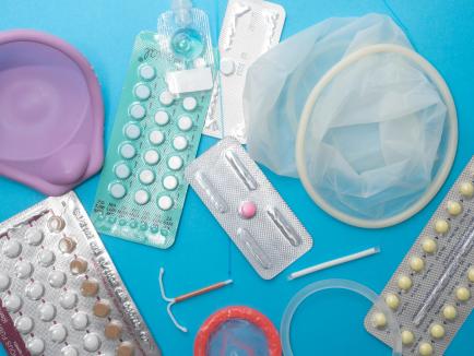 several different birth control methods spread out on a blue background