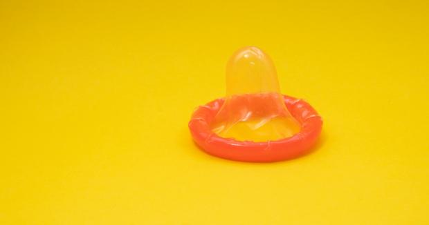 orange condom on a yellow background