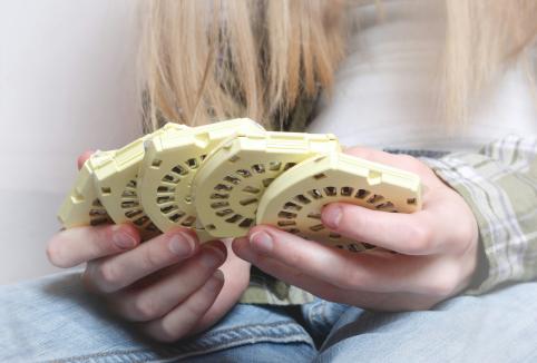 person holding five packs of the contraceptive pill