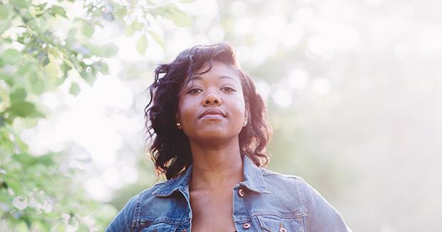 woman looking confident in a denim jacked making eye contact with the camera